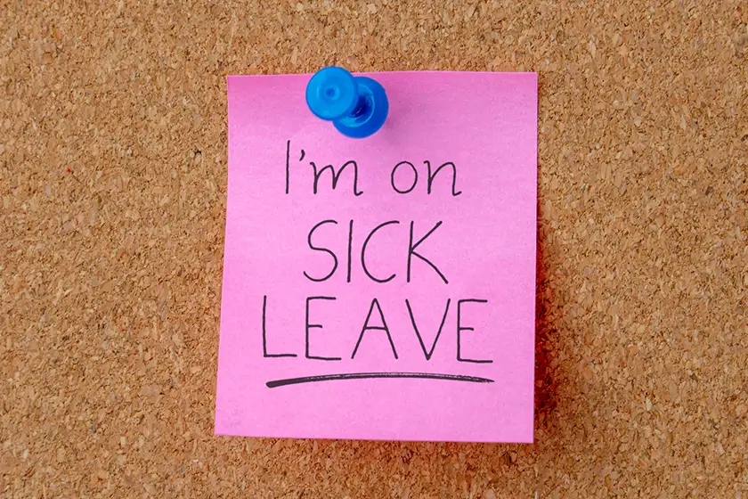 I'm on sick leave post-it note on cork board